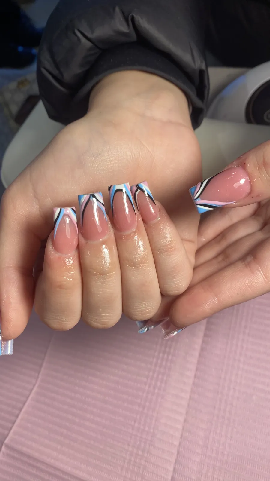 Pink and blue swirl French tip nails