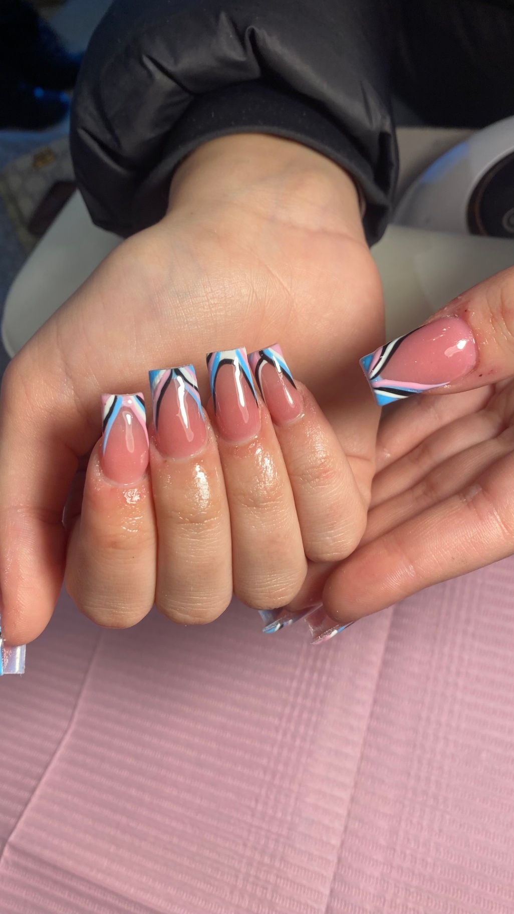 Pink and blue swirl French tip nails
