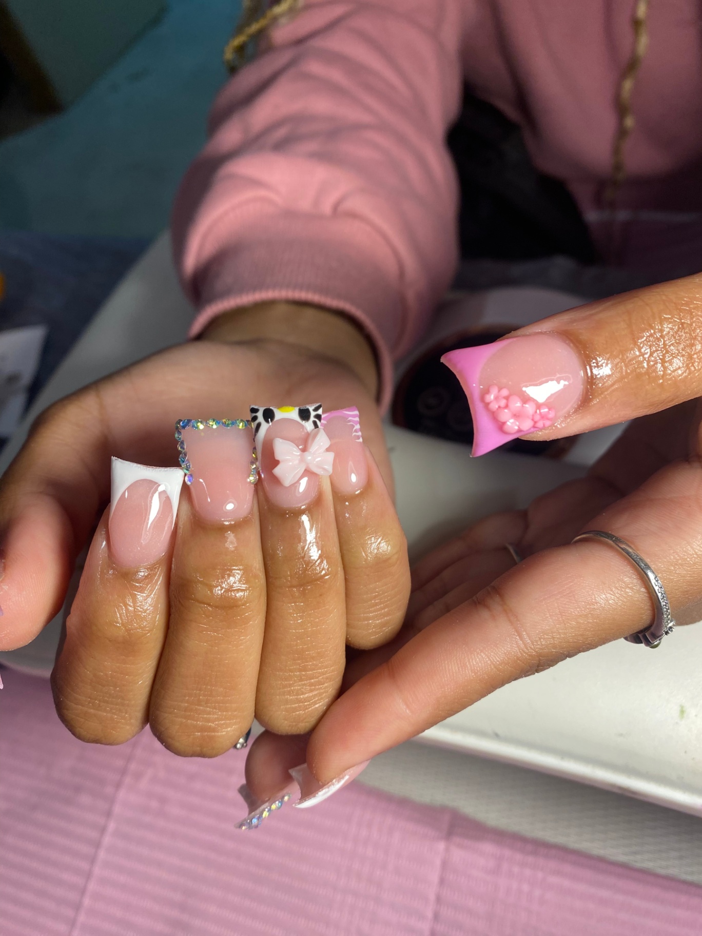 Baby pink nails with bow charm and Hello Kitty accent
